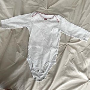 Long sleeve onesie. Has little flower detail at the neckline